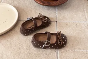 Brown polka dot Mary Jane flats for little girls with cute bow and ankle strap details.