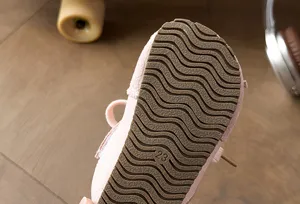 Detalle de suela de zapatillas infantiles, diseño de goma suave con ondas, talla veintitres para ninos.