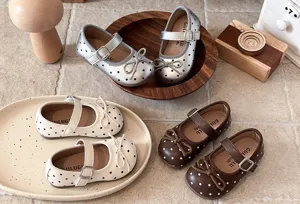 Detail shot of toddler Mary Jane shoes with cute bow and polka dots, soft sole and strap.