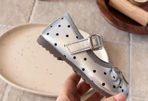 Detailed view of kids silver polka dot mary jane flat shoes with soft sole and cute bow.