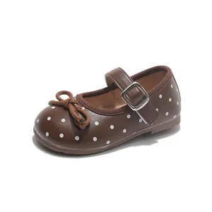 Girls brown polka dot Mary Jane flat shoes with cute bow and buckle strap for kids.