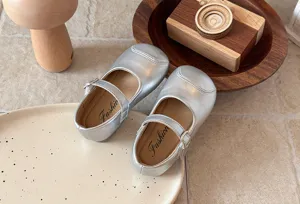 Detailed shot of silver girls Mary Jane flat shoes, soft sole cute princess dress footwear.