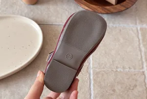 Close-up detail of the soft sole and size marking on the classic girls french shoes.