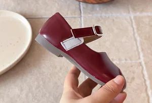 Red Mary Jane girls shoes detail view, soft leather flat shoe with buckle and strap.