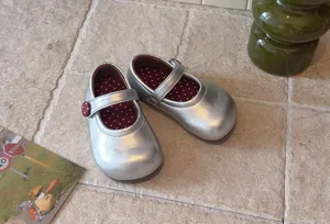Silberne Mädchen Mary Jane Schuhe mit süßem Pünktchenfutter und weicher Sohle im Detail.