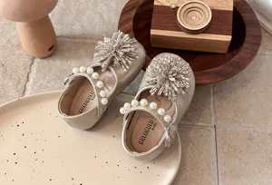 Detailed shot of kids pearl leather shoes with rhinestone flower bow for girls spring.