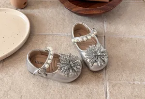 Detailed view of silver toddler princess shoes with pearl straps and sparkling rhinestone toe.