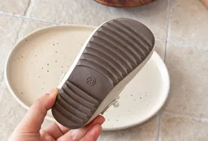 Detail view of girls pearl shoes sole, non-slip textured sole with size 23 marking.