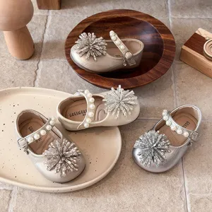 Stylish toddler girls Mary Jane dress shoes with pearl straps and sparkling rhinestone bows.