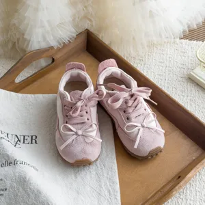 Gros plan sur les details des baskets retro roses pour enfants avec une semelle souple.