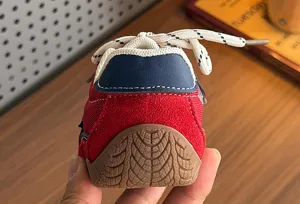 Detailed close-up view of kids retro casual sneakers heel and rubber sole, stylish design.