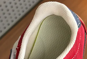 Close-up detail of children's retro sneaker collar, breathable mesh lining, soft and comfortable.