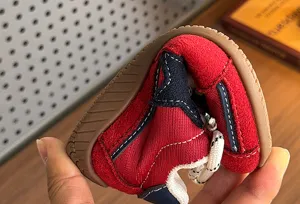 Flexible toddler retro star sneakers detail view, showing soft sole and bending comfort.