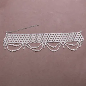 Pearl shoulder accessory detail view, multi-layer beaded choker design, elegant bridal necklace.