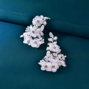 Detailed close-up of white beaded flower appliques, perfect for wedding shoe and garment DIY.