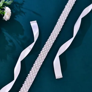 Handcrafted pearl rhinestone white ribbon belt detail view for bridal dress elegant accessory.