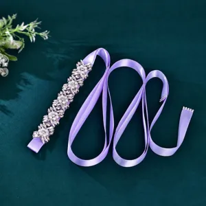 Handmade rhinestone bridal belt detail, sparkling crystals and pearls on lavender ribbon.