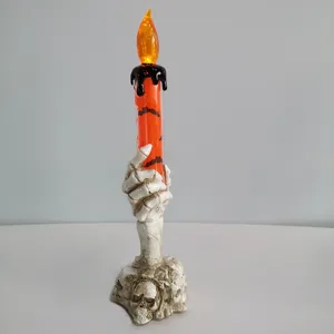 Halloween skeleton hand LED candle lamp detail view, skull base scary decoration prop.