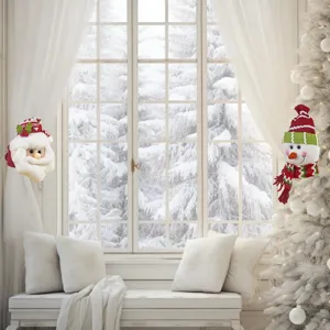 Christmas curtain tieback detail showing cute Santa and snowman plush decorations for holiday decor.
