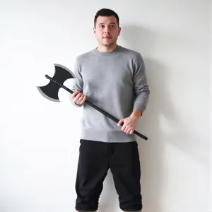 Close-up detail of a black double-bladed toy axe stage prop for Halloween party costume.