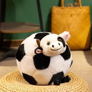 Cute cow soccer ball plush pillow toy, creative stuffed animal doll for home decor and kids.