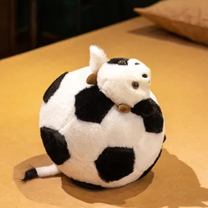 Cute cow soccer plush pillow toy, creative stuffed doll for kids and home decor.