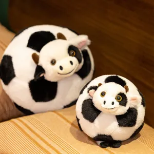 Cute cow football plush pillow toy doll, soft stuffed animal cushion for kids and home decor.