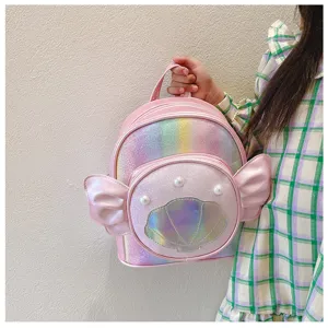 Close-up detail of the pink sparkly shell backpack with cute wings and pearl decor.