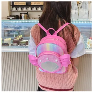 Close-up detail of cute pink glitter kids backpack with shell design in cozy cafe scene.