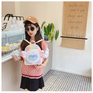 Detailed view of cute holographic kids backpack with shell wing decor for girls daily use.