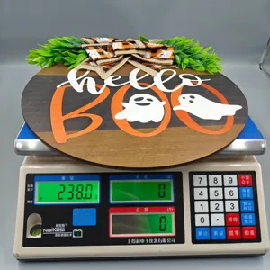 Detailed view of Halloween wooden sign with boo text and ghosts shown on weight scale.
