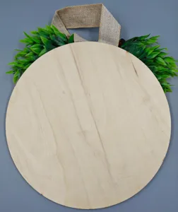 Blank round wooden sign detail with burlap hanger and green leaves decor for DIY crafts.