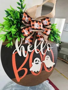 Halloween wooden door sign detail view showing cute ghost and boo lettering craft.