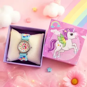 Close-up of children quartz watch with unicorn dial and cute silicone strap in gift box.