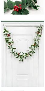 Artificial Christmas holly berry vine garland for indoor wall hanging holiday decor.