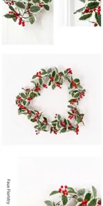 Artificial Christmas holly berry garland detail view, frosted leaves and red berries.