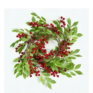 Artificial Christmas wreath with red berries and green holly leaves, perfect for holiday home wall decor.
