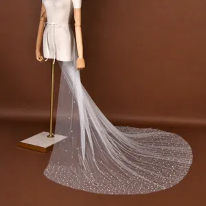 Detachable bridal wedding dress long mesh train skirt with pearl embellishment details.