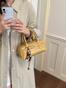Women yellow boston handbag retro PU leather shoulder bag with buckle and charm.