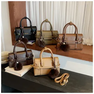 Detailed view of women's PU leather shoulder bag featuring woven texture and chic plush ball charm.