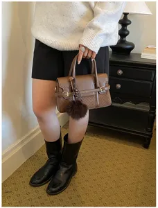 Elegant brown leather top handle bag with woven details, ideal for daily chic commuting.