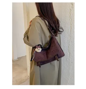 Stylish suede shoulder bag with soft texture, casual crossbody design for daily wear.