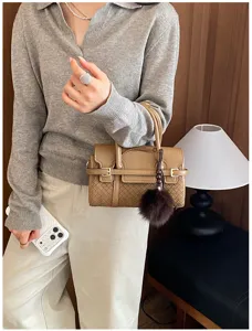 Stylish woven women handbag with top handle and fluffy charm, perfect for daily commute.
