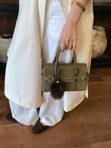 Olive green stylish women handbag shoulder crossbody bag with plush ball pendant for daily commute.