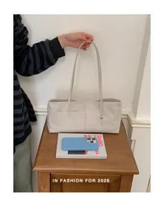 Detailed view of casual minimalist tote shoulder bag with chic key charm and front pocket design.