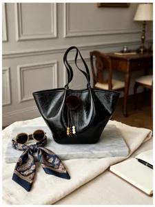 Close-up detail of the black vintage oil-wax leather shoulder bag in a luxury scene.