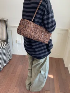 Leopard print shoulder bag for women, stylish underarm tote bag with metal key charm detail.