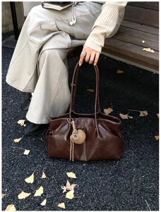 Detailed view of women's vintage large brown tote bag, casual commuting shoulder handbag.