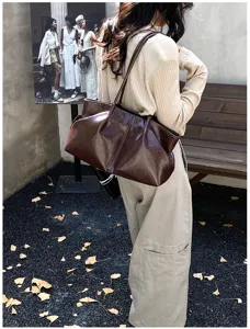 Detail view of the brown slouchy shoulder tote bag, large capacity and vintage commuter style.
