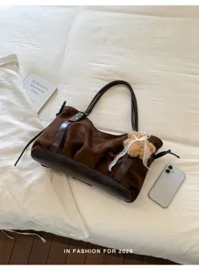 Brown suede underarm shoulder bag detail, stylish retro style with cute plush bear pendant.